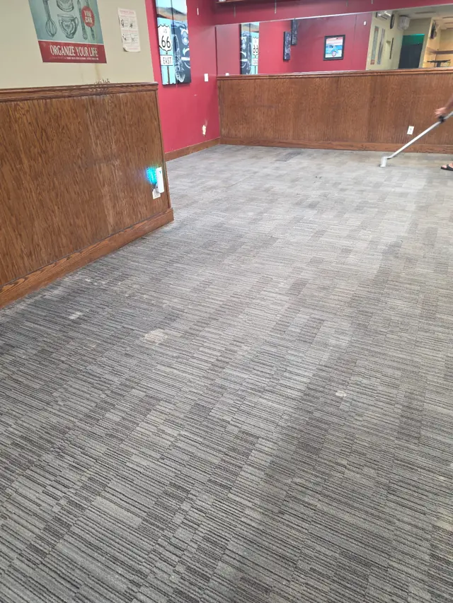 The same restaurant's carpet tile after cleaning, even color with the pattern clear again